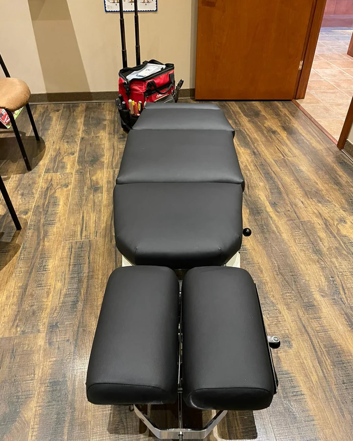 Reupholstered chiropractic adjustment table with segmented cushions