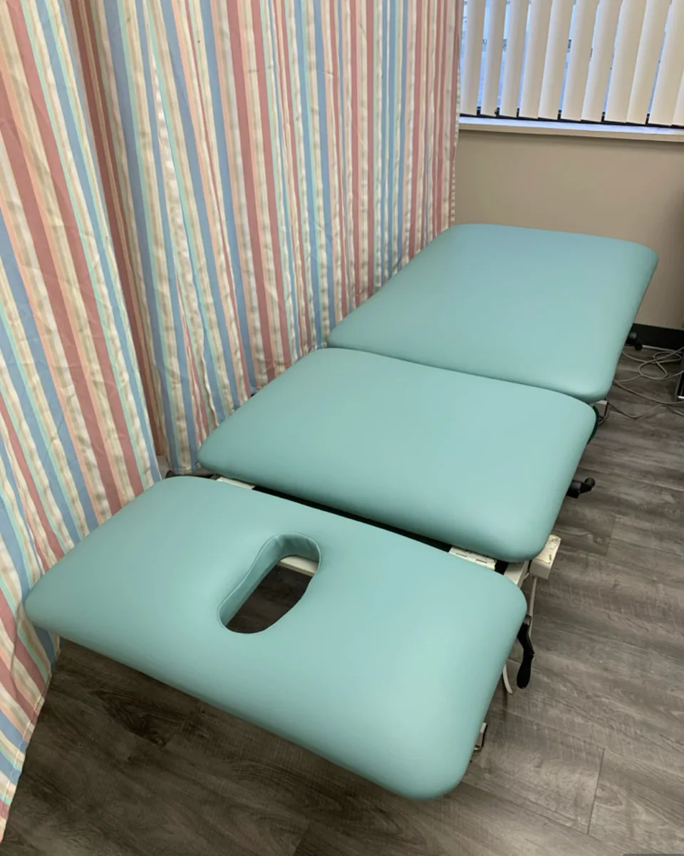 SEERS 3 treatment table with its padded sections upholstered in light spa green vinyl after restoration.
